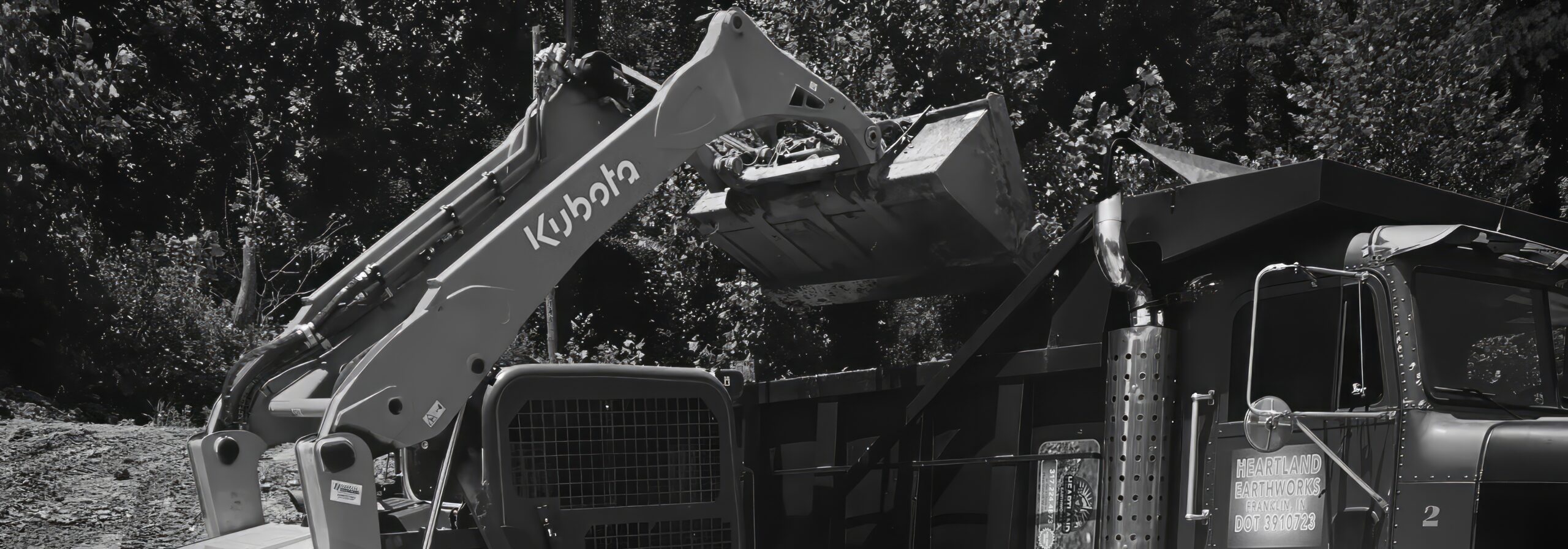 Heartland Earthworks Skid steer loading truck after excavating